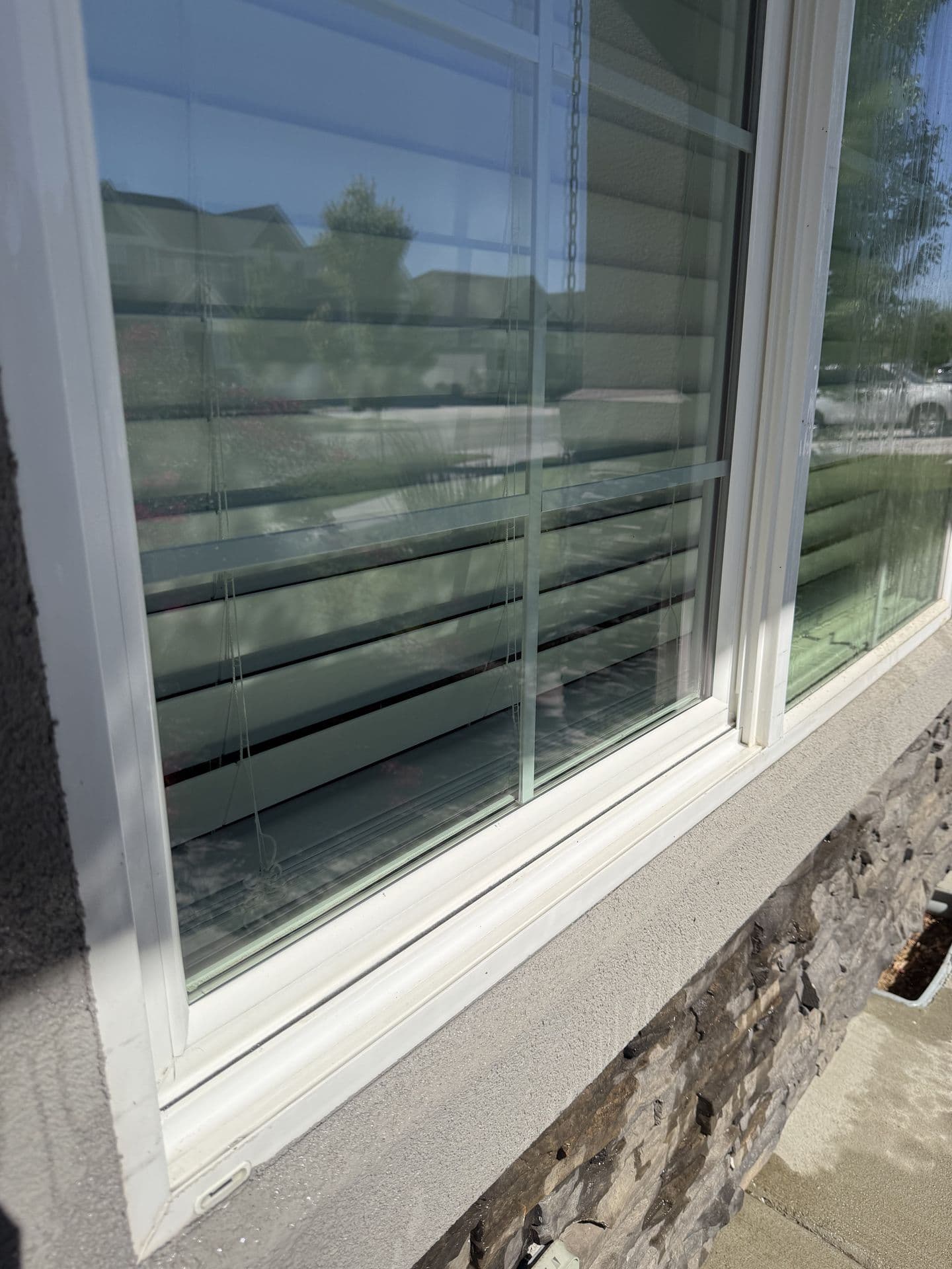 The same sill and glass spotless after hand detailing