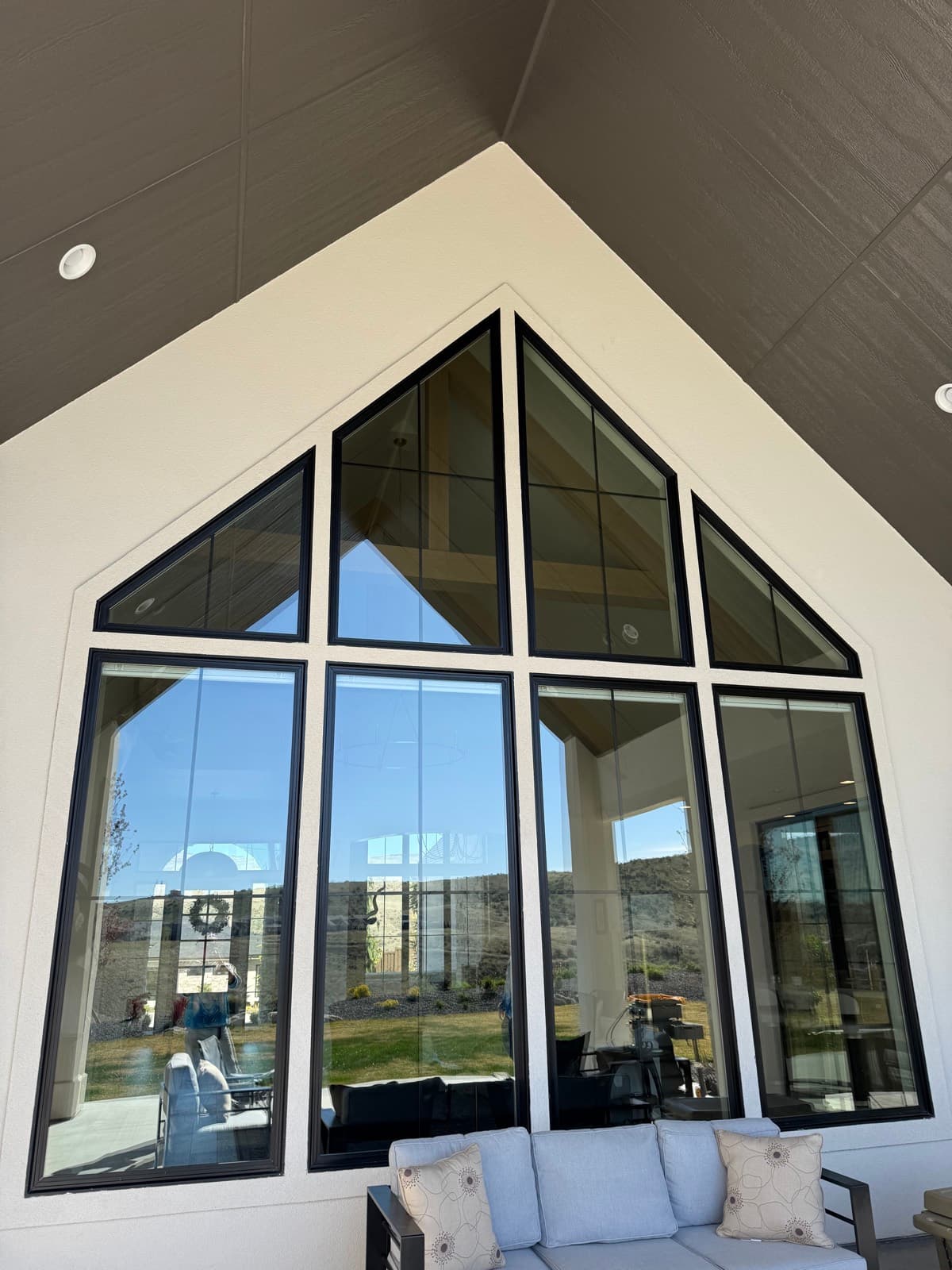 Floor-to-ceiling geometric glass wall, cleaned spot-free